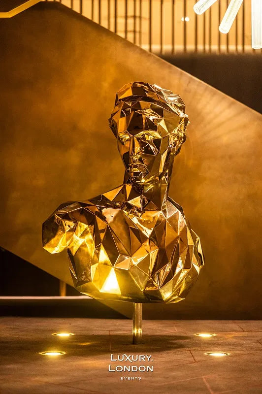 A geometric gold bust sculpture used as venue decoration at the London New Year's Eve Masquerade